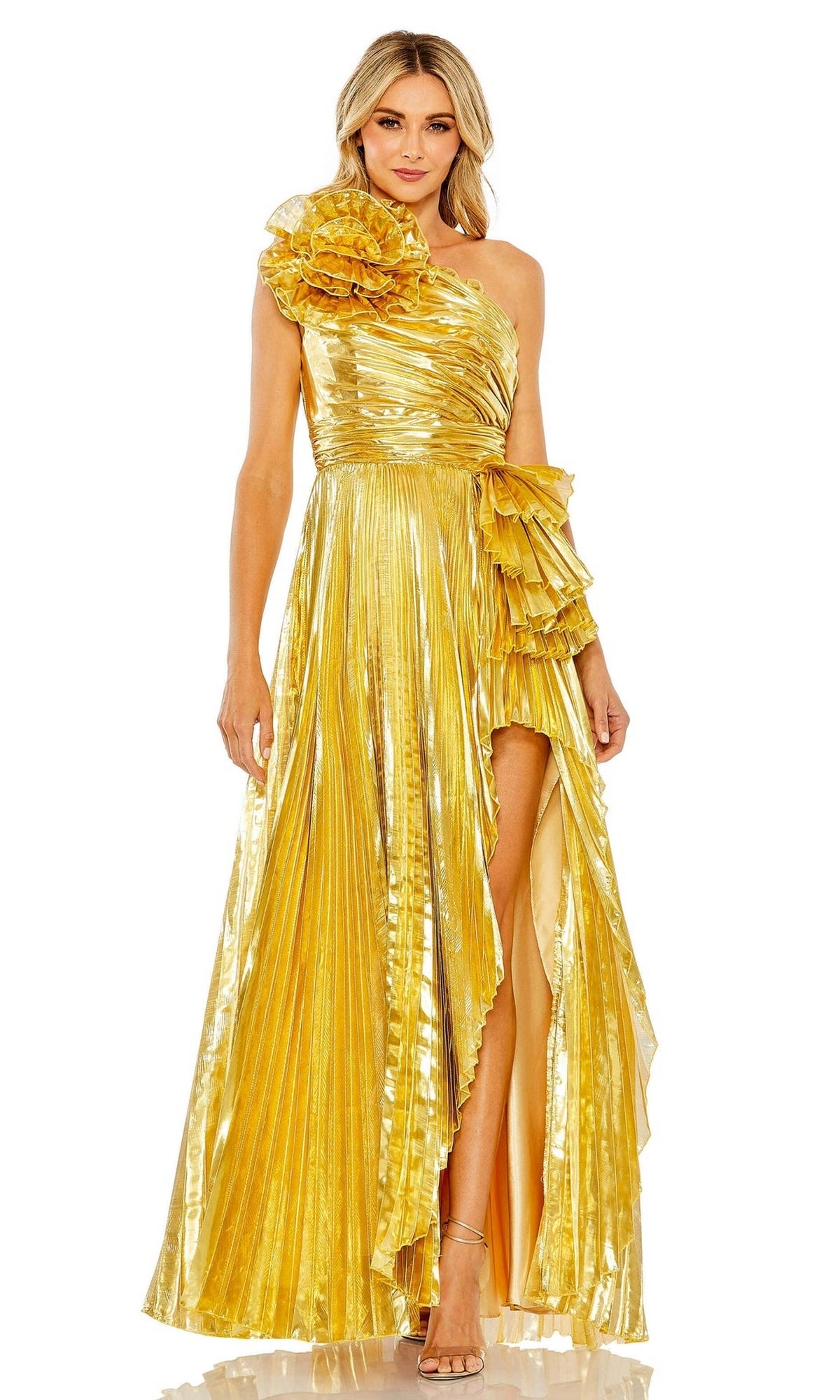 A woman stands confidently facing forward in the Long Formal Dress 11696 by Mac Duggal, featuring metallic pleats, a one-shoulder design, ruffle details, and a high slit.